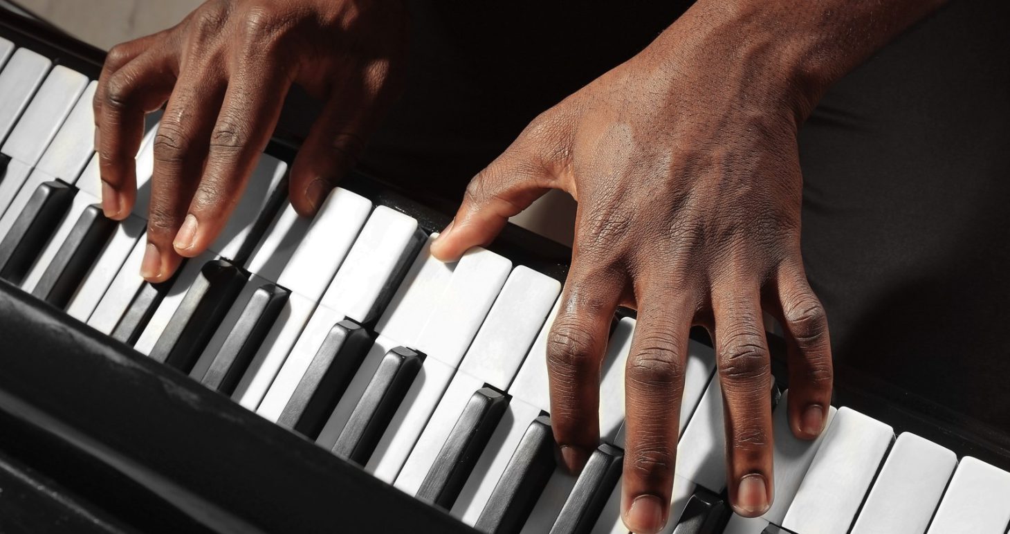 Close-up of hands playing piano keys